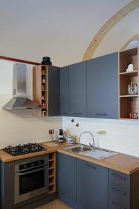 a kitchen with a sink and a stove top oven at Casa Vacanze San Pietro in Canosa di Puglia
