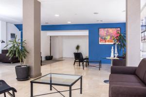 a lobby with a couch and a glass table at RVHotels Mar de Tossa in Tossa de Mar