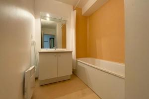 a bathroom with a tub and a sink and a mirror at Les Naïades C12 - 2 bedrooms for 5 people ! in Avène