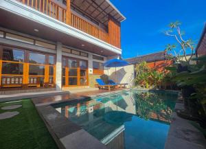 a house with a swimming pool in front of a house at Villa Nuansa Indah 2BR UNGASAN in Uluwatu