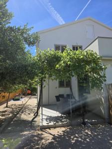 a swing in front of a house at Apartments Manta in Pag