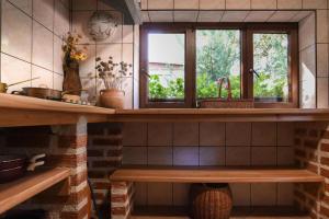 a kitchen with a counter with two windows and a sink at ECO Beach Houses - Pet friendly in Peroj +73 photos