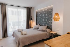 Postel nebo postele na pokoji v ubytování Hulot B&B Valencia