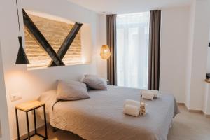 Postel nebo postele na pokoji v ubytování Hulot B&B Valencia