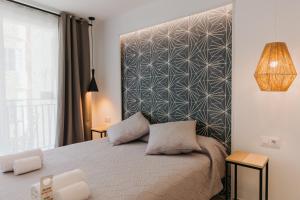 Postel nebo postele na pokoji v ubytování Hulot B&B Valencia
