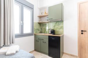 a small kitchen with a sink and a counter at Lelis Studios in Pythagoreio