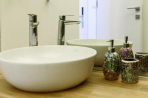 a bathroom with a white sink and two sinks at Astria Palermo - Complex Novum in Olimp +17 photos