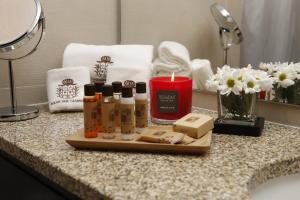 a bathroom counter with a candle and soap and towels at Solar Dos Cáceres in Fornos de Algodres +71 photos