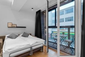 Ένα ή περισσότερα κρεβάτια σε δωμάτιο στο Centrally located modern 1BR Apartment Reykjavik