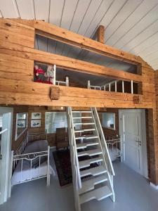a loft bed in a tiny house at Koljonvirta Cottages in Iisalmi