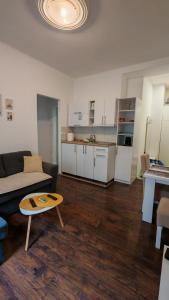 a living room with a couch and a table at ZELENI VENAC Studio & Apartment in Belgrade