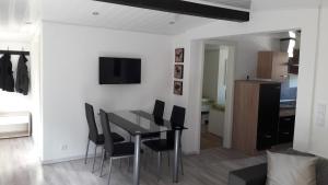 a dining room with a black table and chairs at Ferienhaus 8 in Ahrbrück