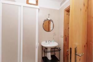 a bathroom with a sink and a mirror at Trullo La Dolce Kuki in La Correggia +21 photos