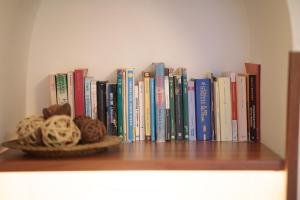 a book shelf with a bunch of books on it at Trullo La Dolce Kuki in La Correggia