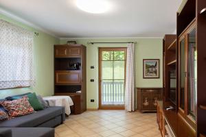 a living room with a couch and a window at Villa Enrica in Transacqua