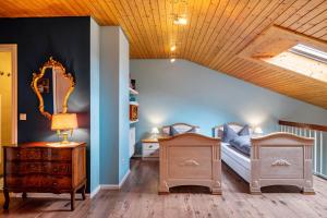 a room with two beds and a mirror in a room at Himmelblau in Schönwald +35 photos