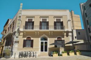 a building with a balcony on the side of it at Hotel Torino in Brindisi