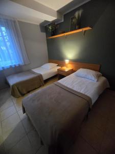 Een bed of bedden in een kamer bij Ośrodek Wczasowy Bursztyn
