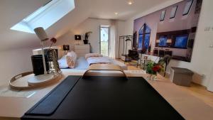a living room with a bed and a table at Apartment Chalet am Schloss Kaltenberg nahe Ammersee in Geltendorf