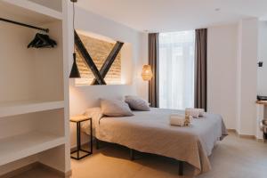 Postel nebo postele na pokoji v ubytování Hulot B&B Valencia