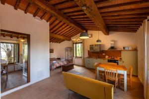 a kitchen and living room with a table and chairs at Agriturismo Il Cocco in Montalcino