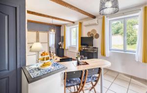 a kitchen with a counter with a table and chairs at Gorgeous Home In Sarlat-La-Canéda in Sarlat-la-Canéda