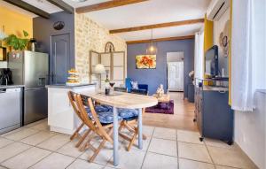 a kitchen with a wooden table and chairs at Gorgeous Home In Sarlat-La-Canéda in Sarlat-la-Canéda