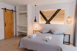 Postel nebo postele na pokoji v ubytování Hulot B&B Valencia