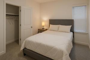 a bedroom with a bed and a lamp on a night stand at Quiet Haven in Richmond