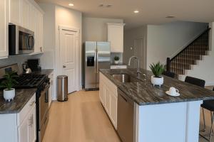 a kitchen with a sink and a refrigerator at Quiet Haven in Richmond +12 photos