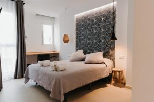 Postel nebo postele na pokoji v ubytování Hulot B&B Valencia