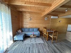 a living room with a blue couch and a table at Resort Dudukovic 2 in Slunj