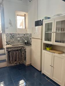 a kitchen with a stove and a sink and a refrigerator at Poseidone 2 in Lipari