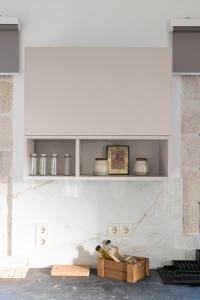 a kitchen with white shelves on a wall at Villa Sofita Komos View in Pitsidia +129 photos