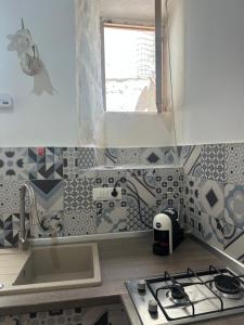 a kitchen with a stove and a sink and a window at Poseidone 2 in Lipari +18 photos