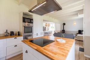 une cuisine avec un comptoir en bois dans une pièce dans l'établissement Un Air de Famille - proche de la plage, à Pleubian 7 autres photos