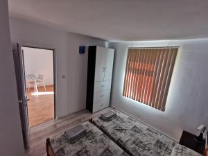 a white room with a bed and a window at Emona 5 floor 4 in Burgas City