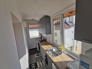 a small kitchen with a sink and a window at Emona 5 floor 4 in Burgas City +4 photos