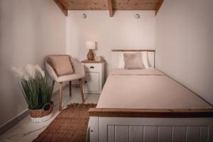 a small bedroom with a bed and a chair at Villa Kamaria with Private Pool and Sea View, by ZanteWize in Alykes +21 photos