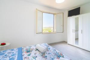 Ένα ή περισσότερα κρεβάτια σε δωμάτιο στο La Tonnara