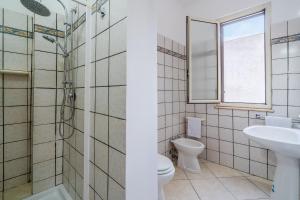 a bathroom with a toilet sink and a shower at La Nassa in Pachino +10 photos