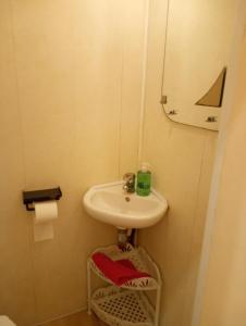a small bathroom with a sink and a mirror at Welcome Apartments in Odessa in Odesa +16 photos