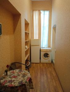 a small room with a refrigerator and a washing machine at Welcome Apartments in Odessa in Odesa