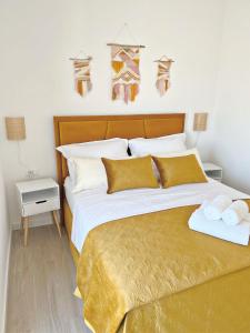 a bedroom with a large bed with towels on it at Apartments Laganini in Primošten