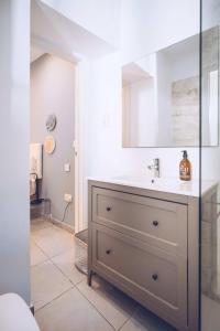 a bathroom with a sink and a mirror at 1BR hidden gem at the Nook in Gibraltar