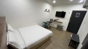 Voodi või voodid majutusasutuse Benz 賓士溫泉旅館 toas