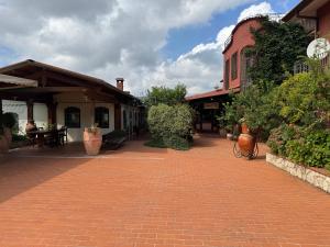 a brick walkway in front of a building at Agriturismo Barbitto in Sezze