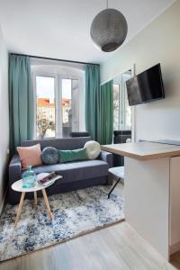 a living room with a couch and a table at Elite Apartments Old Town Center Premium in Gdańsk