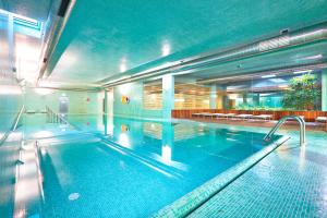 a large indoor swimming pool in a building at Golden Residence Hotel in Funchal