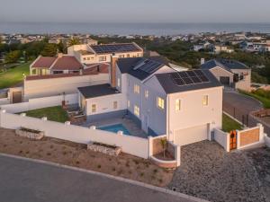 an aerial view of a house with solar panels on the roof at Vermont Vista - With Pool in Hermanus